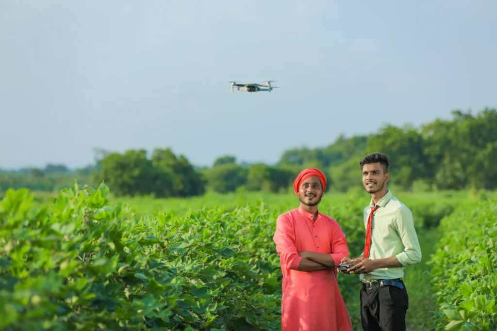 Indian farmer using a drone to check an agricultural field